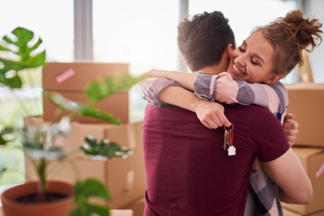 Happy couple moving into new home.