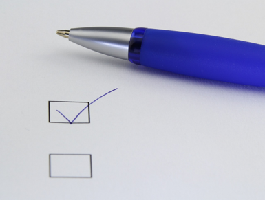 Pen beside a checklist with checkmarks, illustrating steps to prepare for property financing.